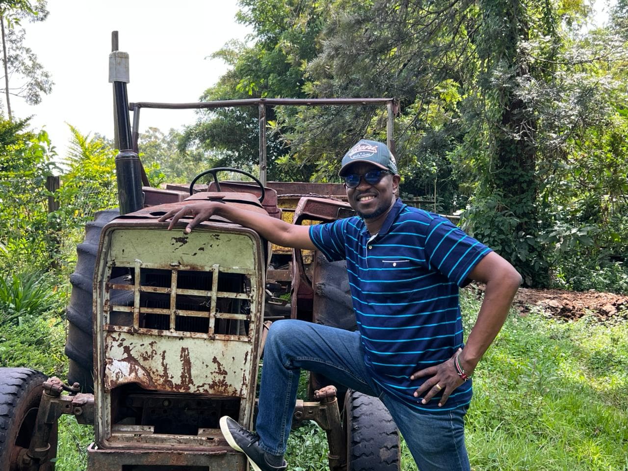 OKIRAT founder with farm equipment